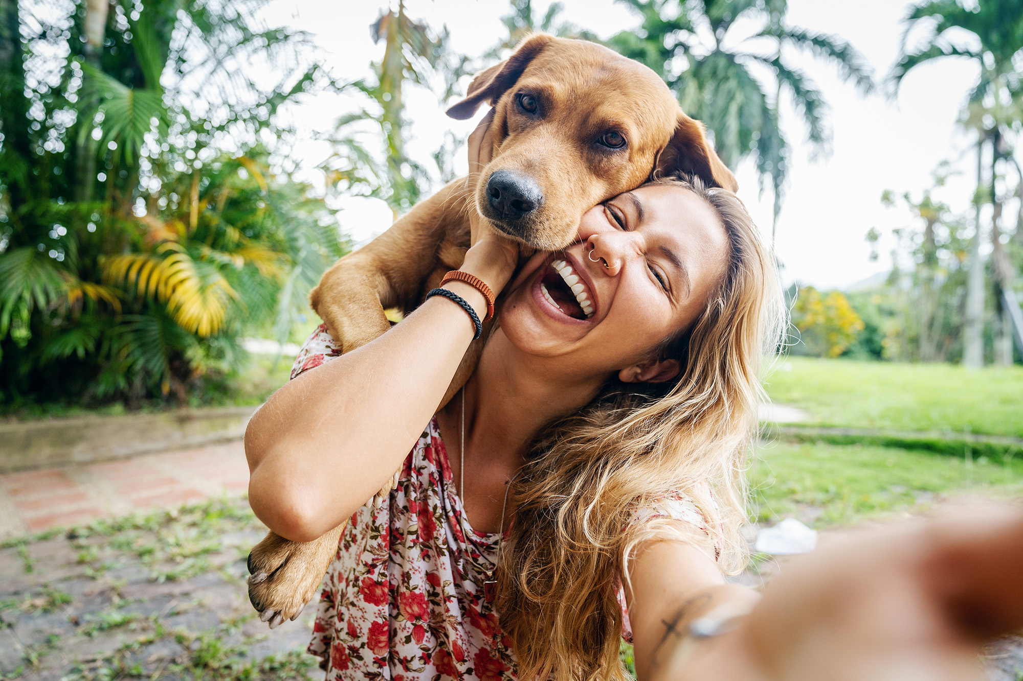 Woman and dog snuggling outside